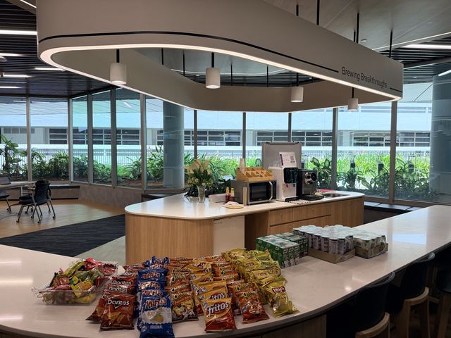 Chips, drink cartons and canned drinks arranged on a refreshment counter